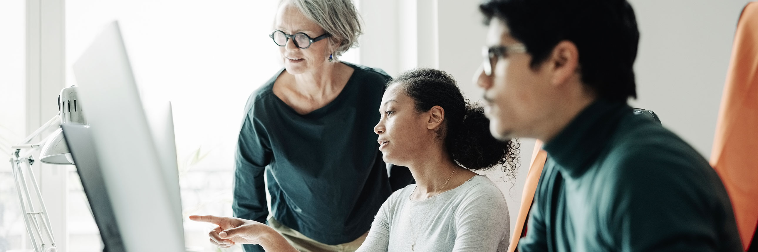 women in the office infront of computer
