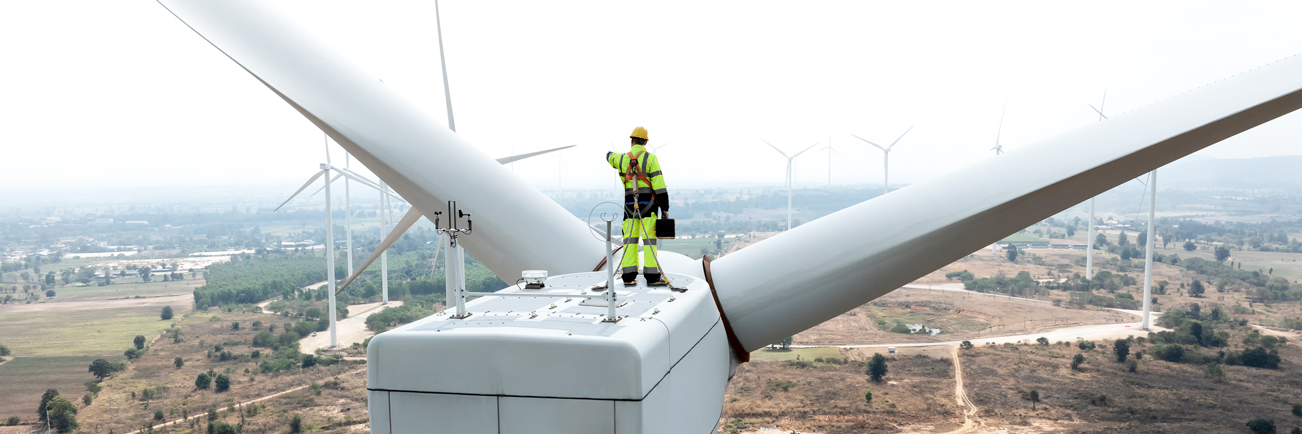 man on top of a Wind turbine