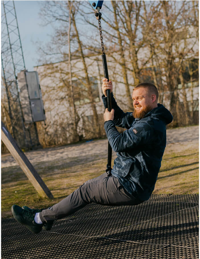 Niklas, mandlig pædagog, prøver en svævebane og smiler stort